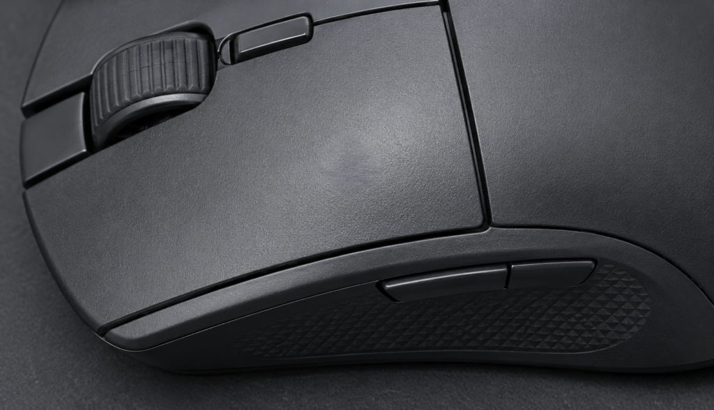 Macro top-down view of gaming mouse left button showing actuation wear mark