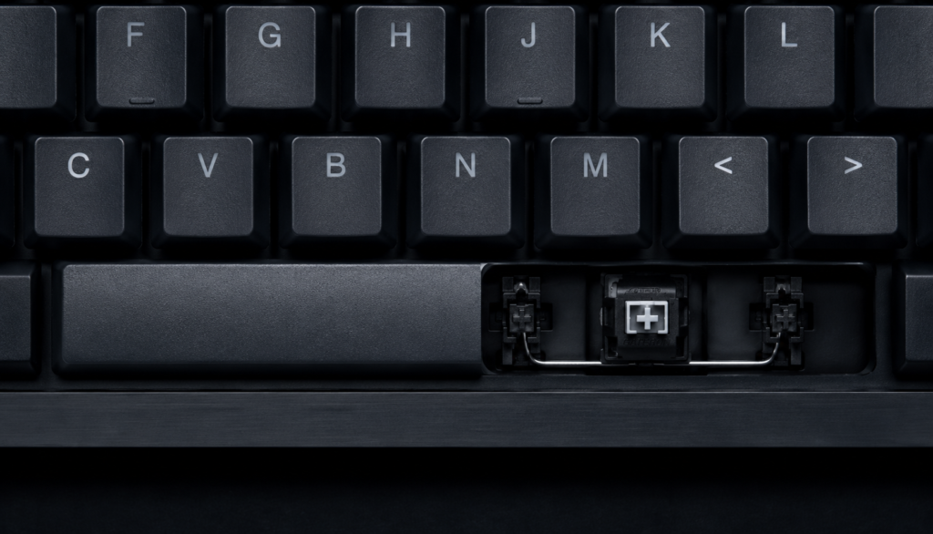 Mechanical keyboard spacebar with keycap removed showing switch stem and stabilizer