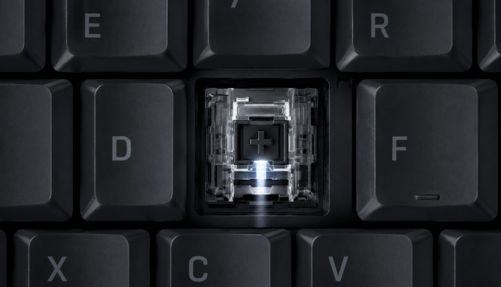 Macro view of optical switch with light beam visible inside mechanical keyboard