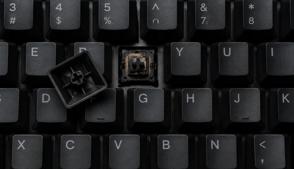 Mechanical keyboard switch showing visible wear with keycap removed