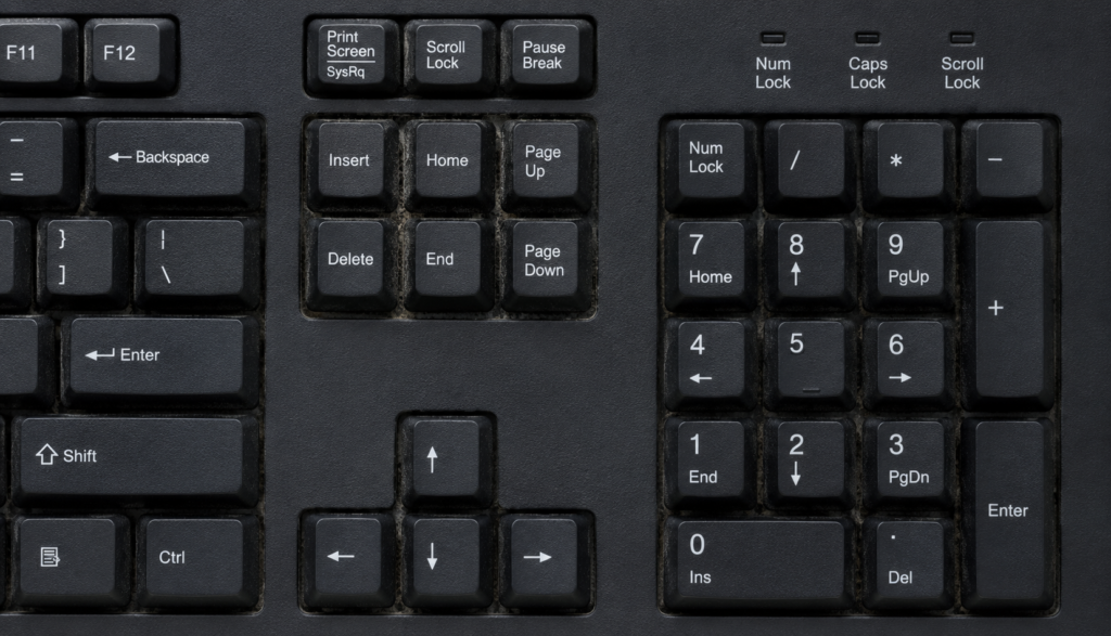 Top-down view of keyboard number pad with dust buildup in rarely used keys